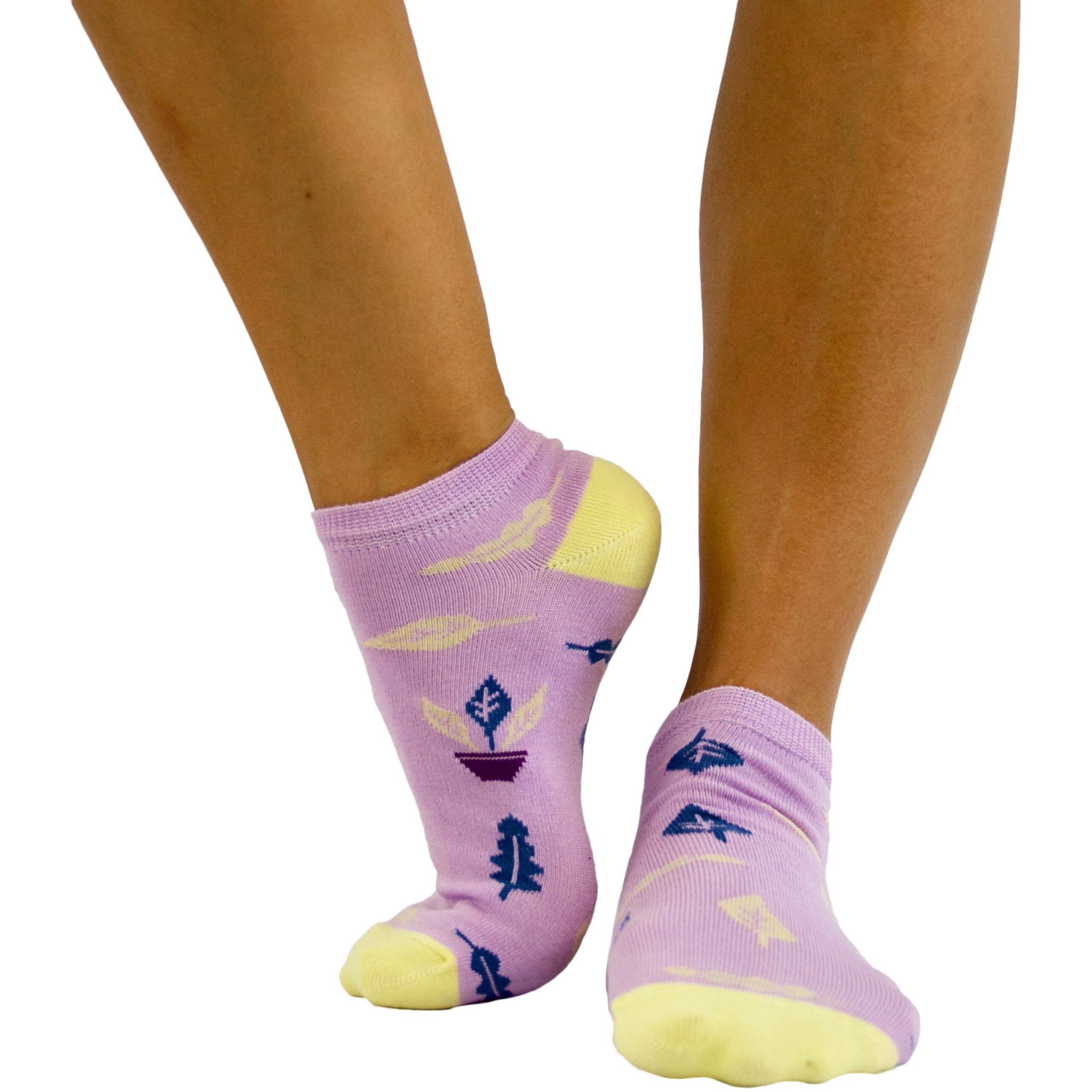 A woman's legs with a pair of colorful socks.